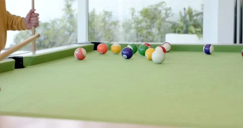 Player is placing cue ball, aligning stick and striking to break colored balls Stock Footage 337097316