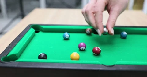 Player plays mini billiards with balls and a cue on table Video stock 291922747