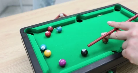 Player plays mini billiards with balls and a cue Video stock 291923770