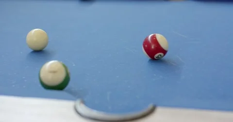 Player pulling cue stick, striking cue ball, sending 14 and 3 balls into corner Stock Footage 334999649