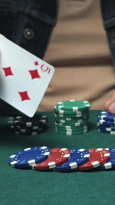 Player reveals poker hand with five of diamonds and five of clubs while Stock Footage 338412221