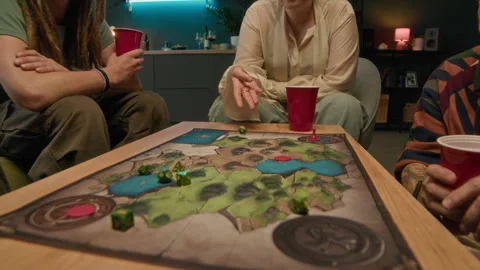 Player Rolling Dice while Playing Board Game with Friends at Home Stock Footage 294360693