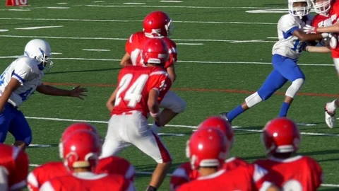 A player scores a touchdown while playing American football, slow motion. Stock Footage