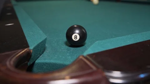 Player sinking black 8-ball into corner pocket to win game of billiards. Stock Footage 102295225