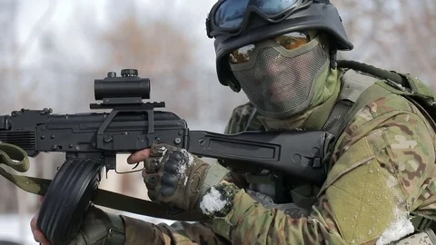 The player is in the snow, and fired from automatic weapons. Play airsoft in the Stock Footage 73035922