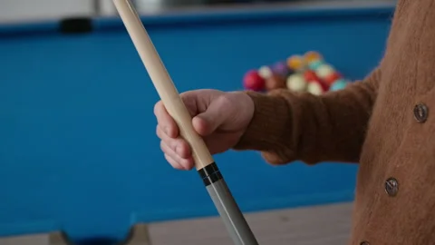 Player Twisting Cue before Pool Game with Break Shot in Background Stock Footage 332766382