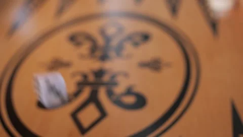 A player's hand is rolling a dice on the backgammon game board, closeup shot Видео 292157051