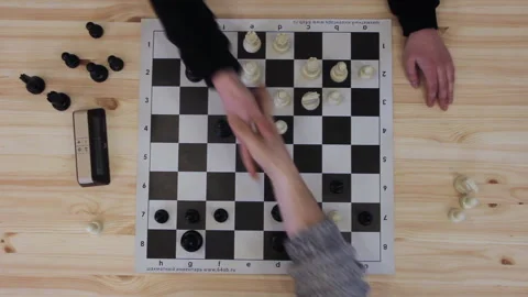 Players place pieces on the board. Two men plays in speed chess on wooden table Stock Footage 205314031
