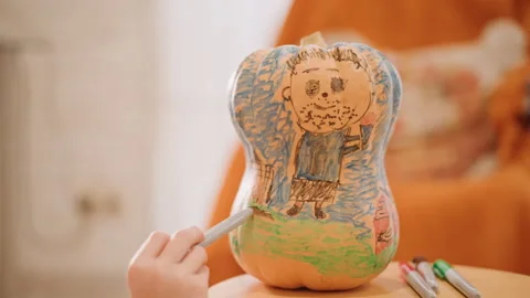 Playful artistic hands create colorful pumpkin illustration scene. Detailed Stock Footage 346395603