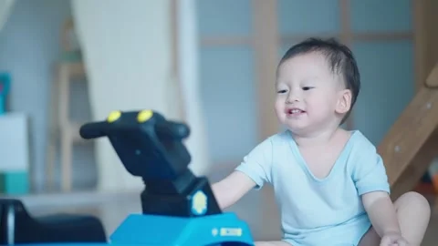 Playful asian boy playing with pushing bike toys at home. Stock Footage 279505849