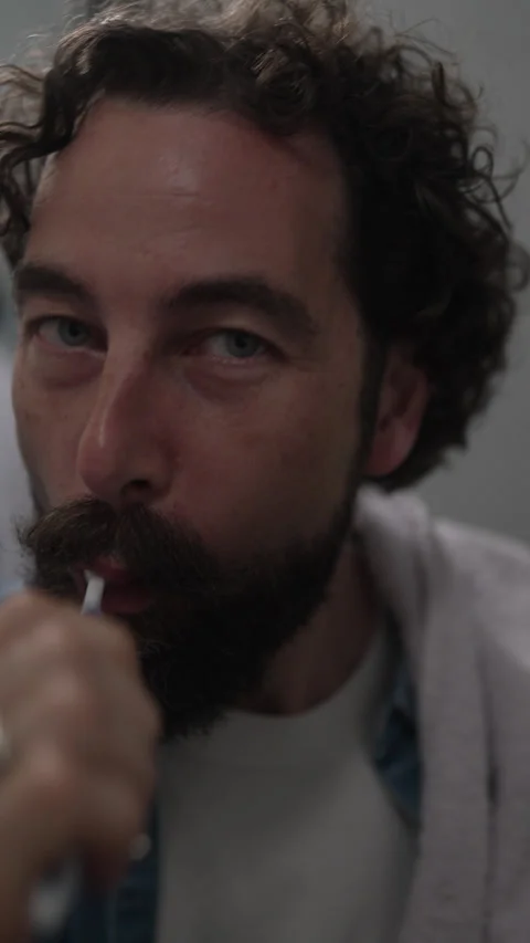 Playful bearded man brushing his teeth in the morning Stock Footage 336624731