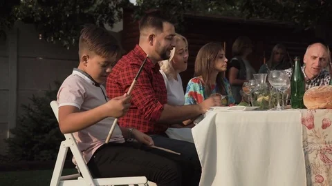 Playful boy with drum sticks at table Stock Footage