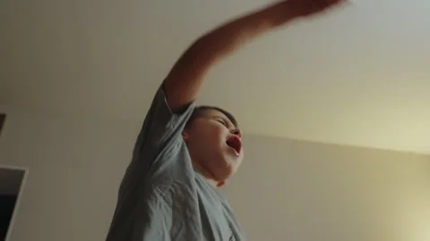 Playful boy gesturing while playing alone at home. Stock Footage 264466086