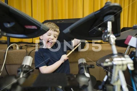 Playful boy playing drum kit at Grace Baptist Church Stock Photos
