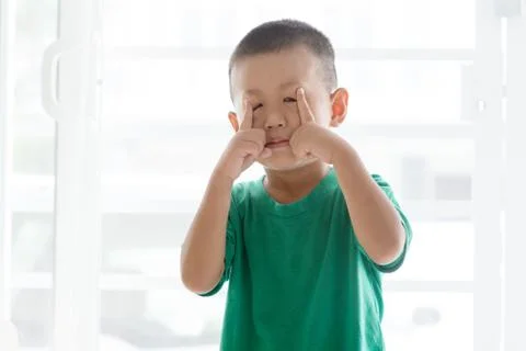 Playful boy pulling face Stock Photos
