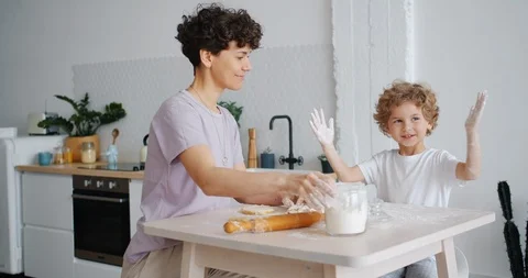 Playful child clapping hands dirty with flout and laughing cooking with mother Stock-Footage 114167904