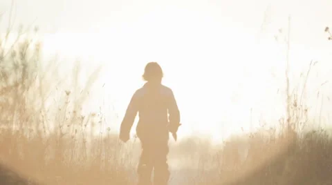 The playful child with a toy at sunrise.Happy boy playing with a toy bird. Stock Footage 59100789