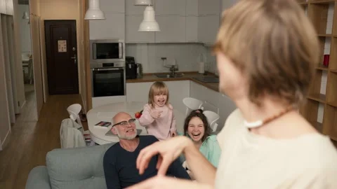 Playful crazy young daddy performing parody to guess together with a family in Video stock 230022229