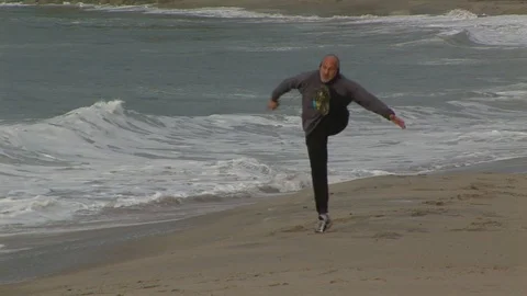 Playful dancer on beach in Laguna Beach, California USA Stock Footage 101488633
