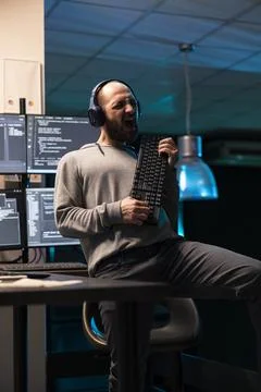 Playful Developer Pretending Keyboard Is Guitar Stock Photos