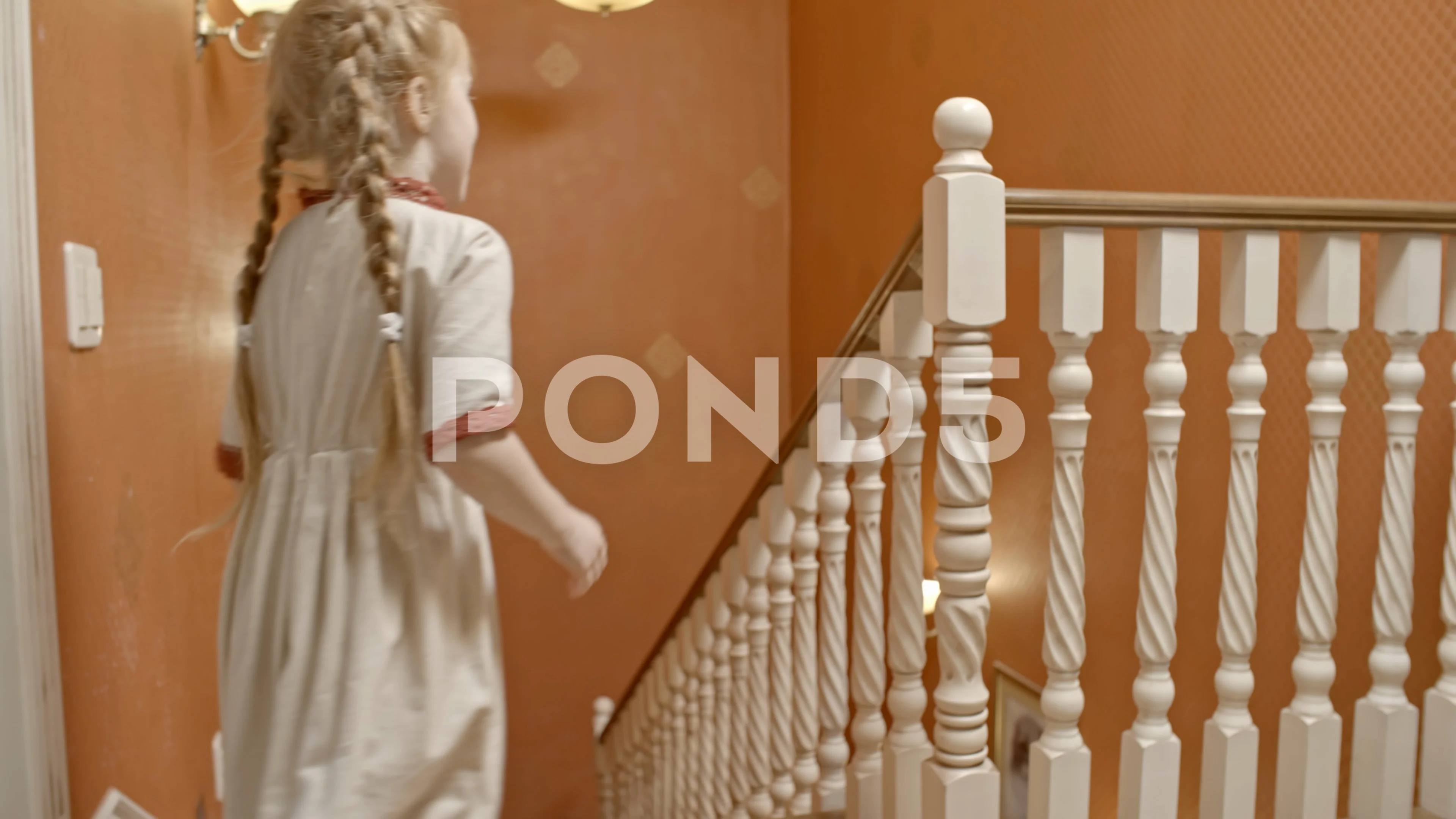 Playful Girl Sliding Down Staircase Railing Clip 77501057