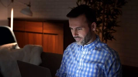 Playful man using a laptop at night Stock-Footage 101323518