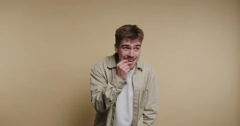 Playful moments captured in four frames of a young man expressing joy and c.. Video stock 329113130