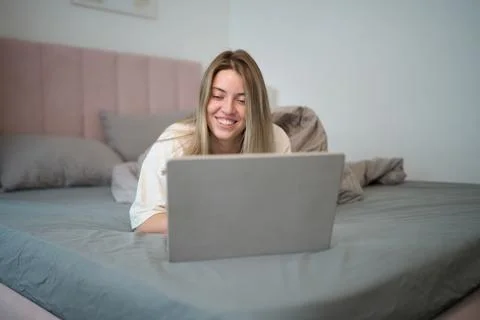 Playful Morning Browsing While Resting in Bed Stock Photos