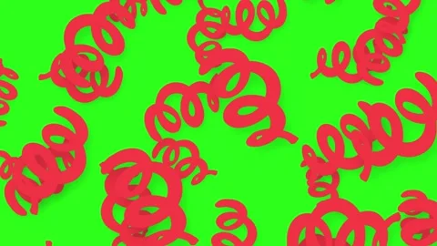 Playful Red Spiral Objects Falling Against a Vibrant Green Background Stock Footage 345317073