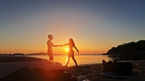 Playful Romantic Couple Dancing And Spinning At Sunset Beach In Slow Motion Video stock 335699001