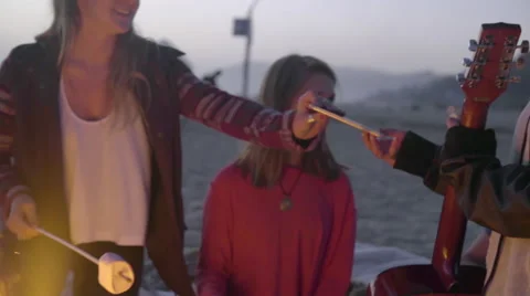 Playful teens by the fire Stock Footage 53257647