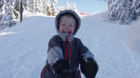 Playful Young Boy Throws Snowball - 4k - Slow Motion Stock Footage 77880748