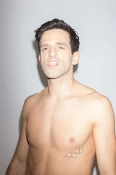 Playful young man posing making fun of himself Stock Photos