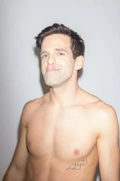 Playful young man posing making fun of himself Stock Photos