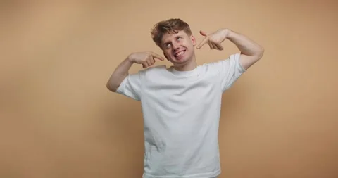 Playful young man showing different emotions in a creative studio setting w.. Stock Footage 317328046