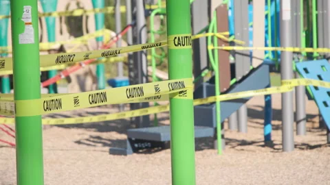 Playground area cordoned off with caution tape due to safety concerns Stock Footage 312698931