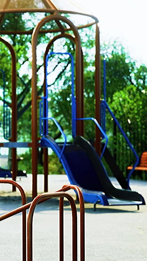 Playground area with slides and climbing structures in a park setting Stock Footage 336575567
