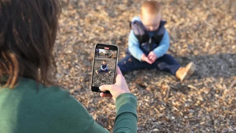 In the playground, the boy sits on the ground and plays with the ground, expl Stock Footage 272563595