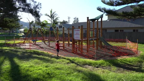 Playground Closure with boy looking Covid-19 Pandemic Werri Beach Australia 1of5 Stock Footage 130424288