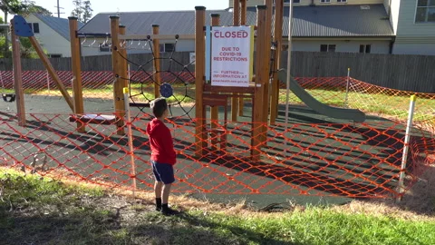 Playground Closure with boy looking Covid-19 Pandemic Werri Beach Australia 2of5 Stock Footage 130427808