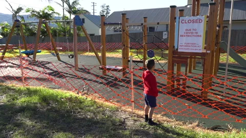 Playground Closure with boy looking Covid-19 Pandemic Werri Beach Australia 3of5 Stock Footage