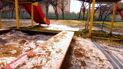 Playground covered with first snow at golden hour Stock Footage 220200056