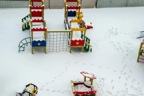 The playground is covered with fresh, loose snow. Snow fell asleep all around. Stock Photos