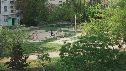 Playground in a large green courtyard Stock Footage 107988360