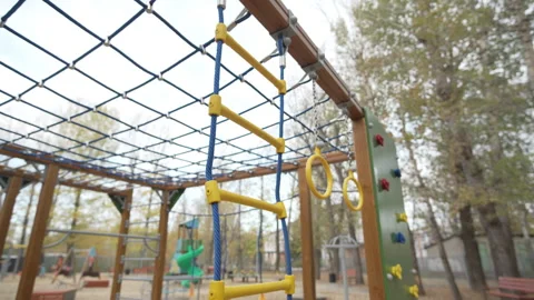 Playground with nets and ladders stands in quiet courtyard Stock Footage 308960228