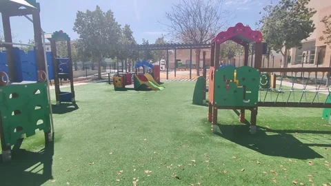 Playground in the park. Empty swing on yard in city on playground Stock Footage 295562590