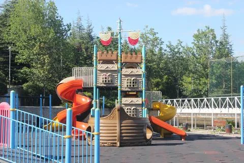 Playground in the park with multi-colored slides and swings. Foto stock
