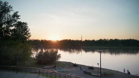 Playground on the riverbank at sunset Vídeos de archivo 245691743