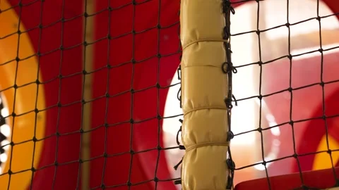 Playground safety net protecting an empty red and yellow plastic slide 스톡 동영상 348331748