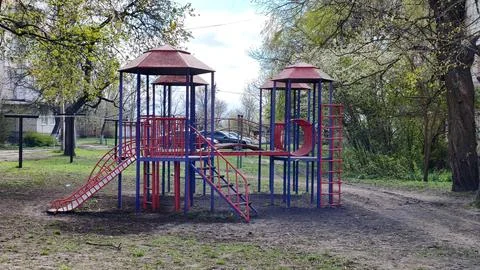 Playground with slides and climbing structures in yard, Stock Photos